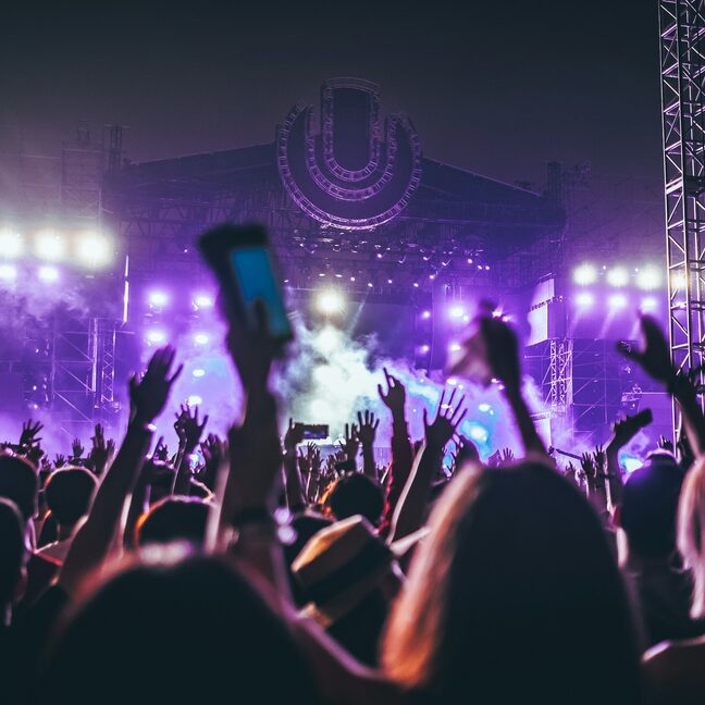 A crowd holding phones up at a live show